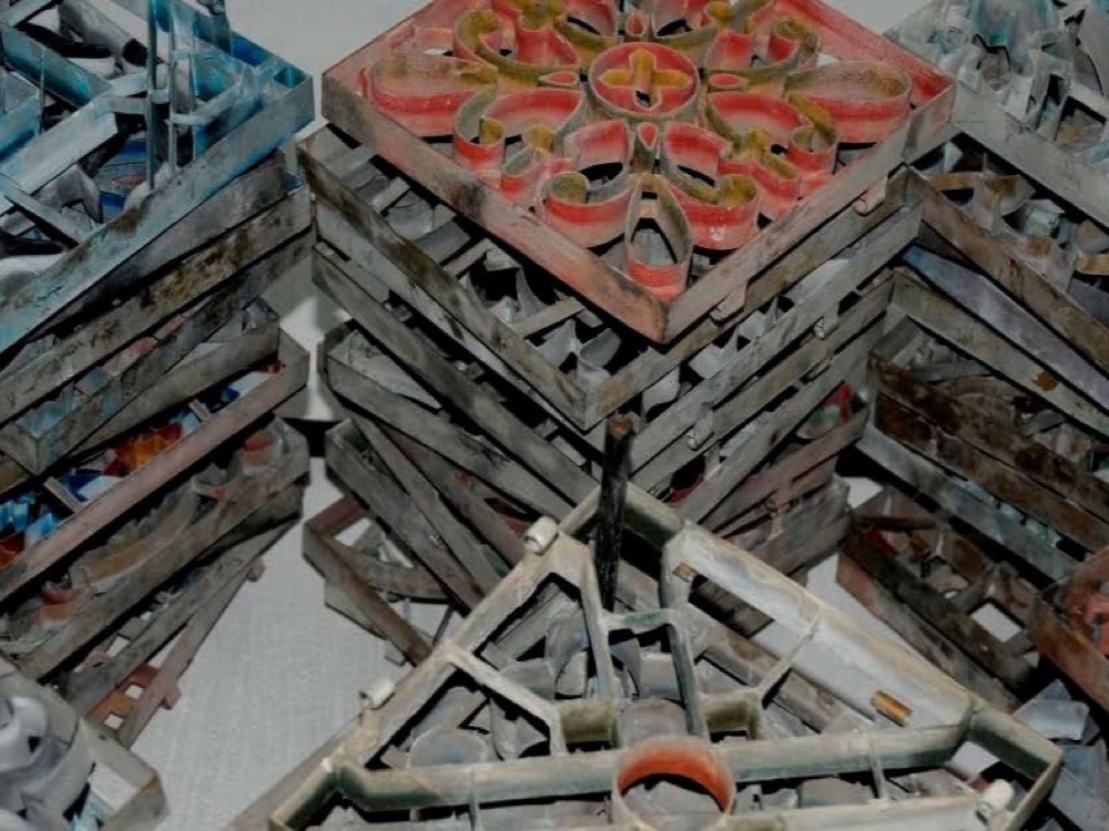 Stacked metal tile moulds stained with pigment