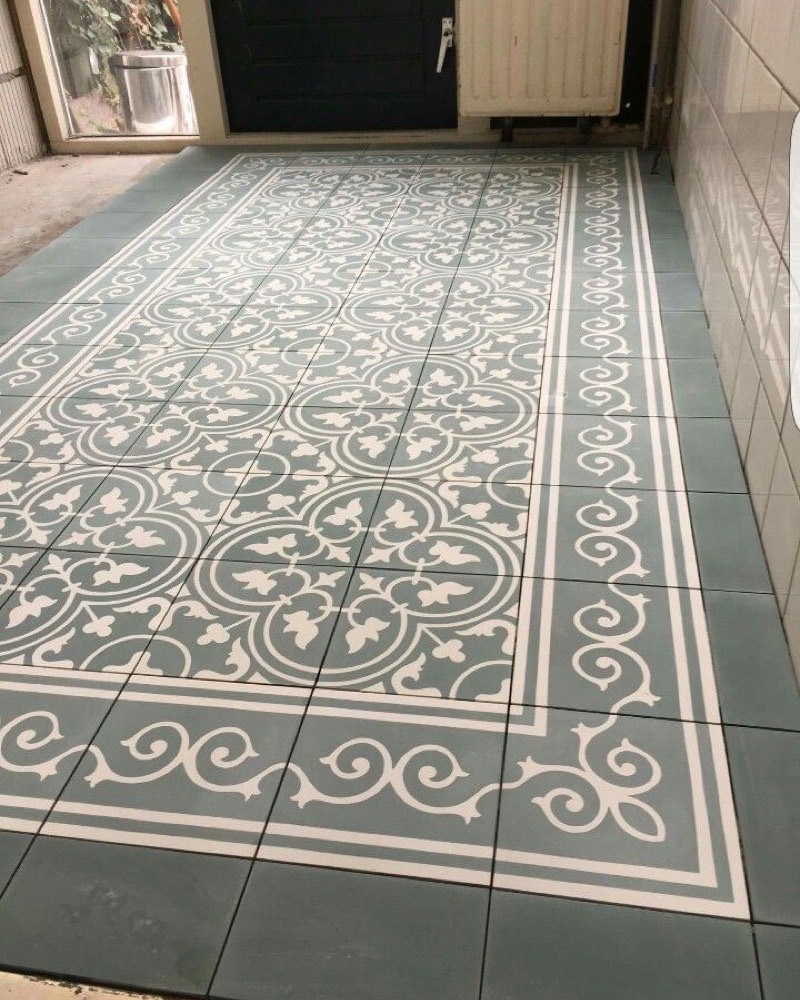 Sage-green heritage pattern floor with a scrolled border