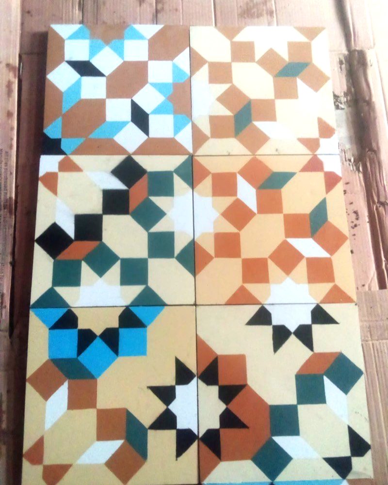 Geometric cement tiles in teal, ochre and terracotta